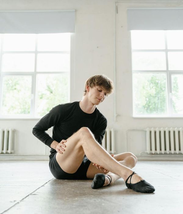 Man performing a foundational strength exercise in a minimalist setting.